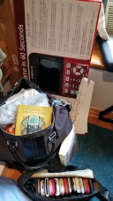 Bags packed, from calculators to books and tablecloths to bookmarks and poster board.