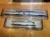 Dual unpowered Acela locomotives and powered HHP-8 locomotive, in packaging.